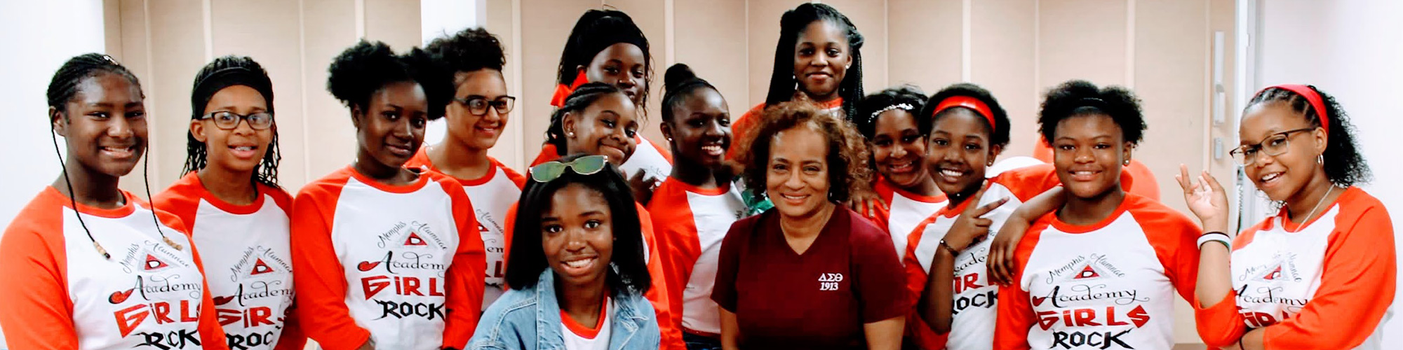 Image of Vera Hawkins with 13 young ladies wearing Memphis Alumnae Academy Girls Rock t-shirts.