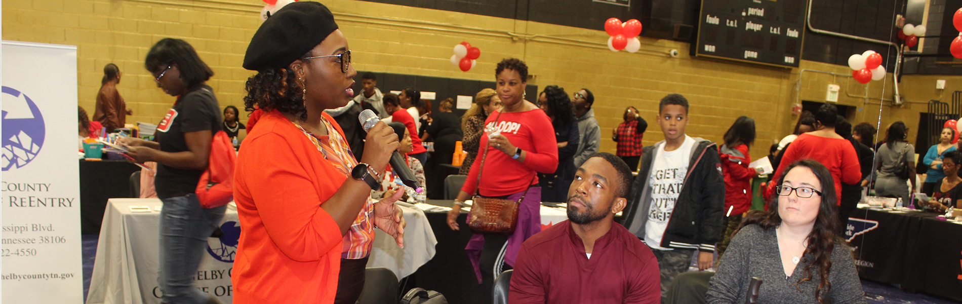 Image of member talking to individuals at a workshop.